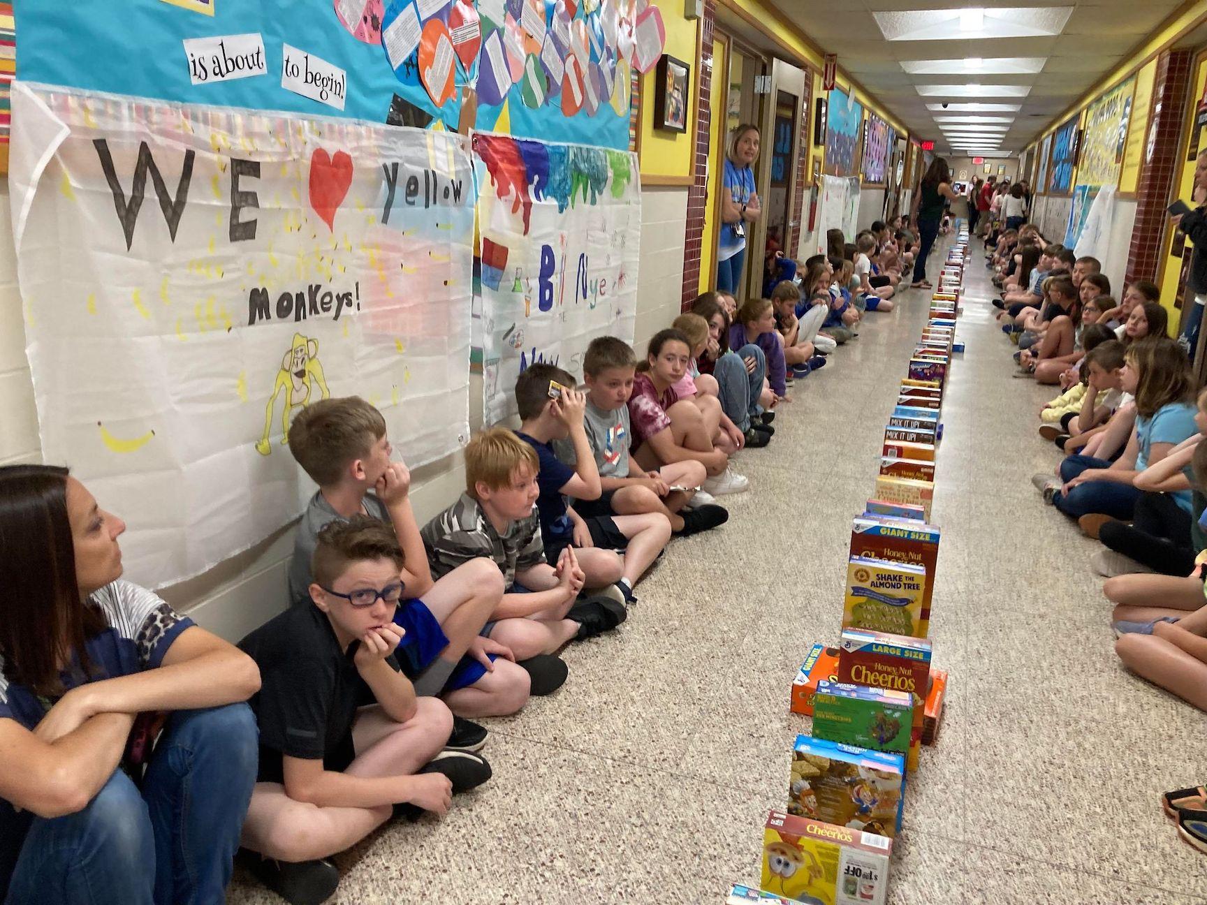students watch the domino effect