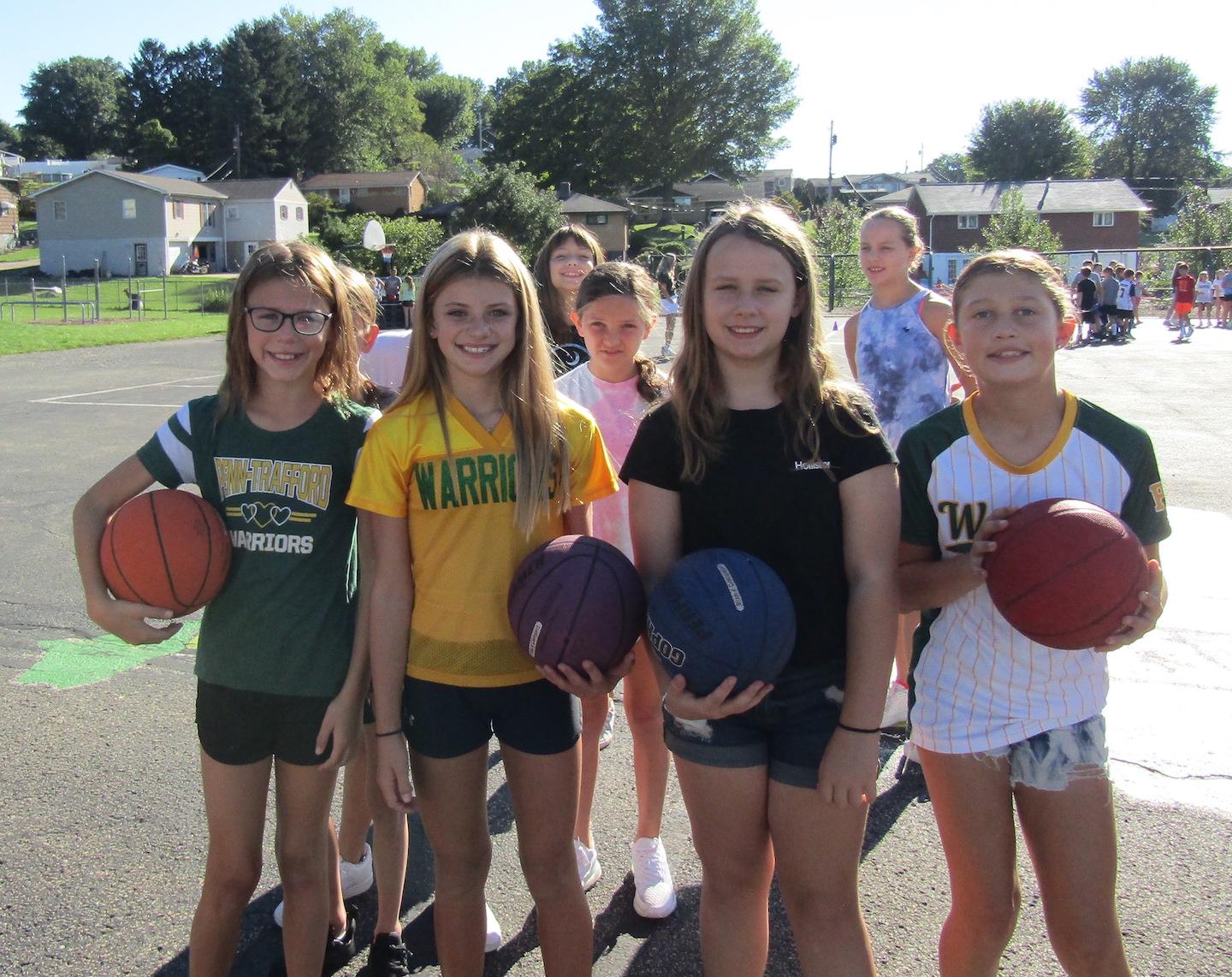 Fifth-graders Adrianna Chapkis, Sydney Ponko, Breanna Walker and Natalia Gunstrom spend some time on the basketball court