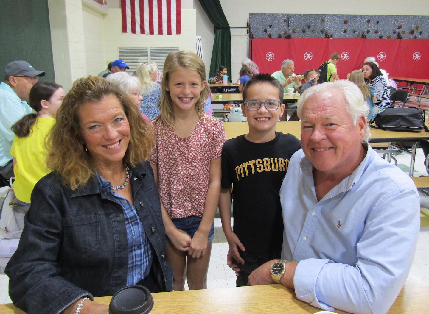 Taylor and Griffin Mutzabaugh, fourth and second grade, pose for a picture with their guests