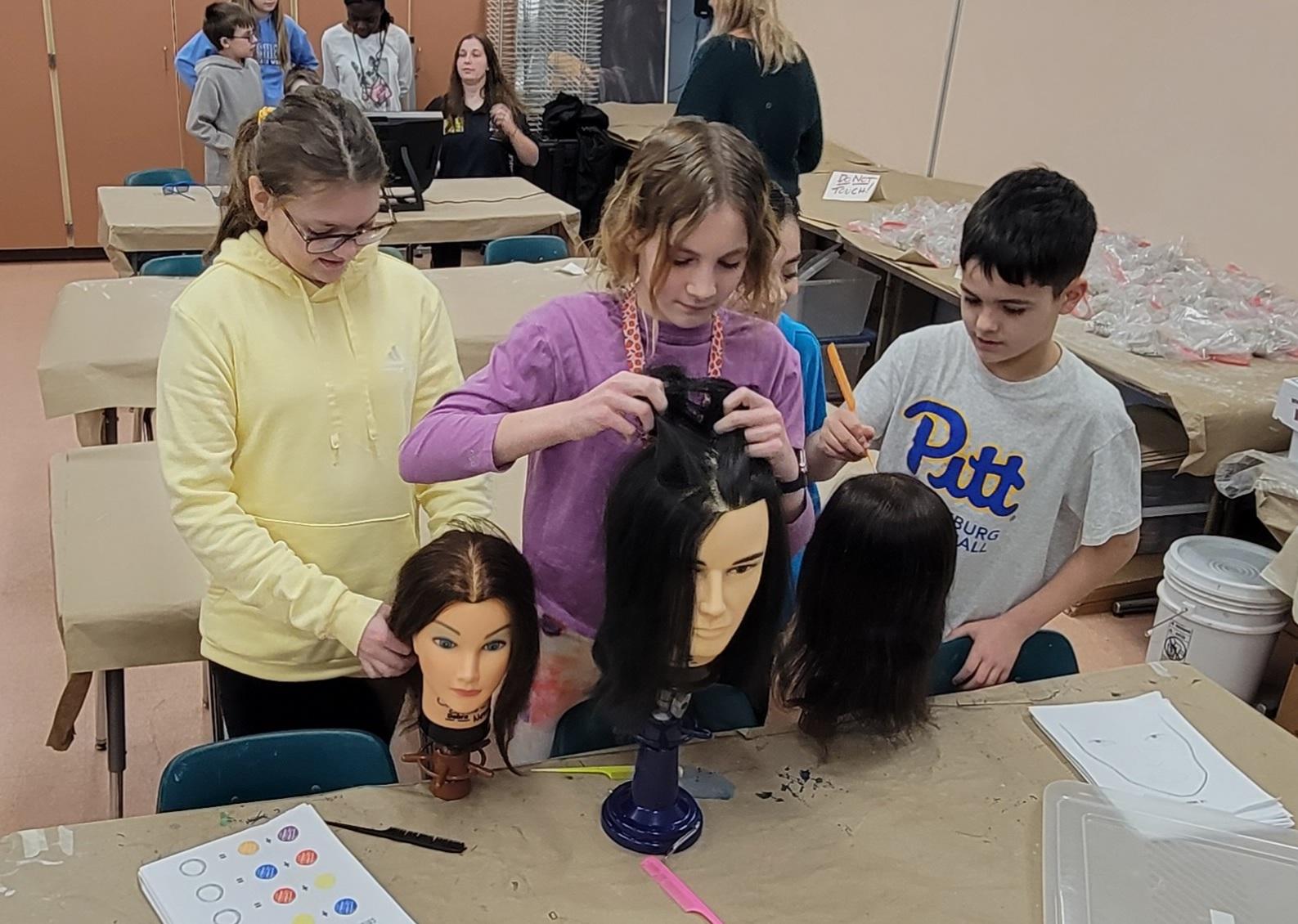 Sunrise Students Maddie DelRosso, Kinsley Rayburg, Chase Butler, and Heath Lekovitch try their hands at the cosmetology station