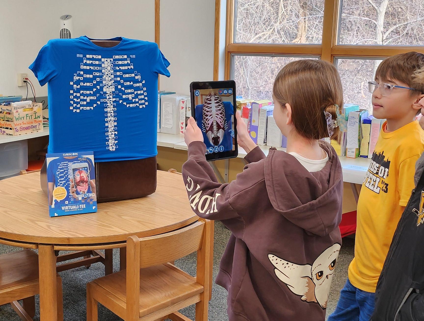 Harrison Park student Willow Simpson uses the virtual human anatomy station to learn about the healthcare program at CWCTC while Caleb Fox observes