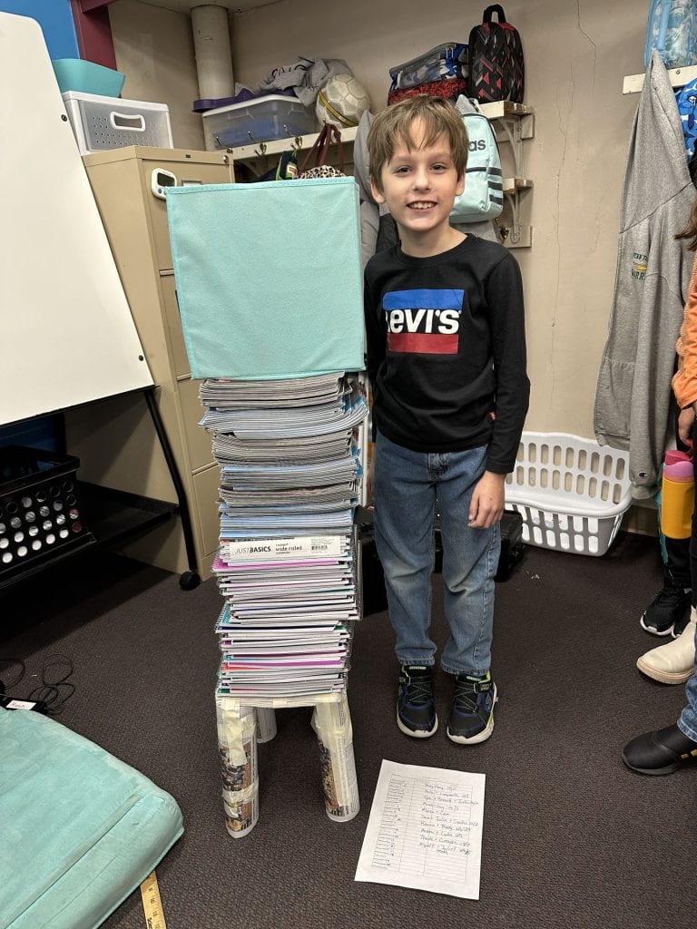 4th-grader Andrew Bittner achieved quite a tower of books on his table