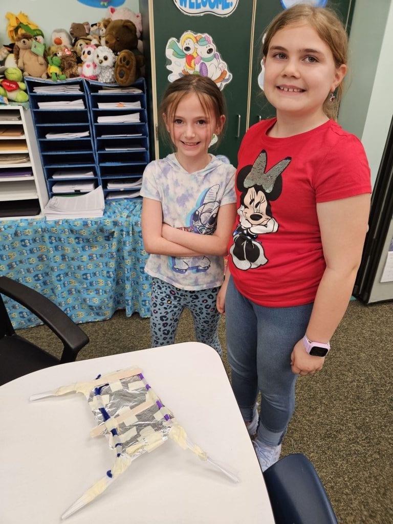 3rd-graders Olivia Evangelista and Gracie Ressler with their finished contraption