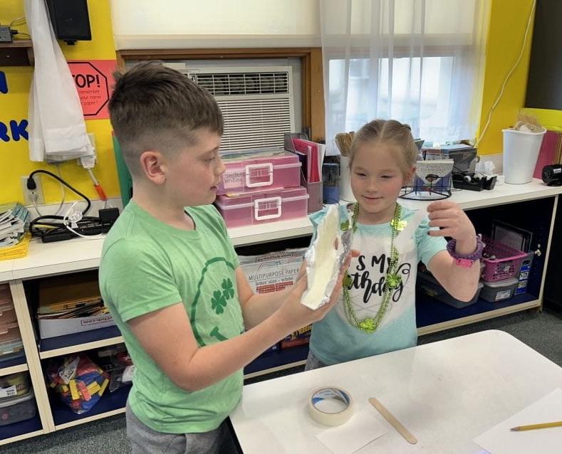 2nd-graders Cruz Kamensky and Gemma Page work together on the project